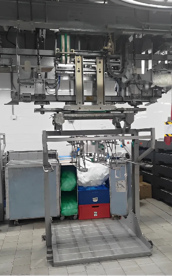 Automated guided vehicle positioned below overhead handling equipment